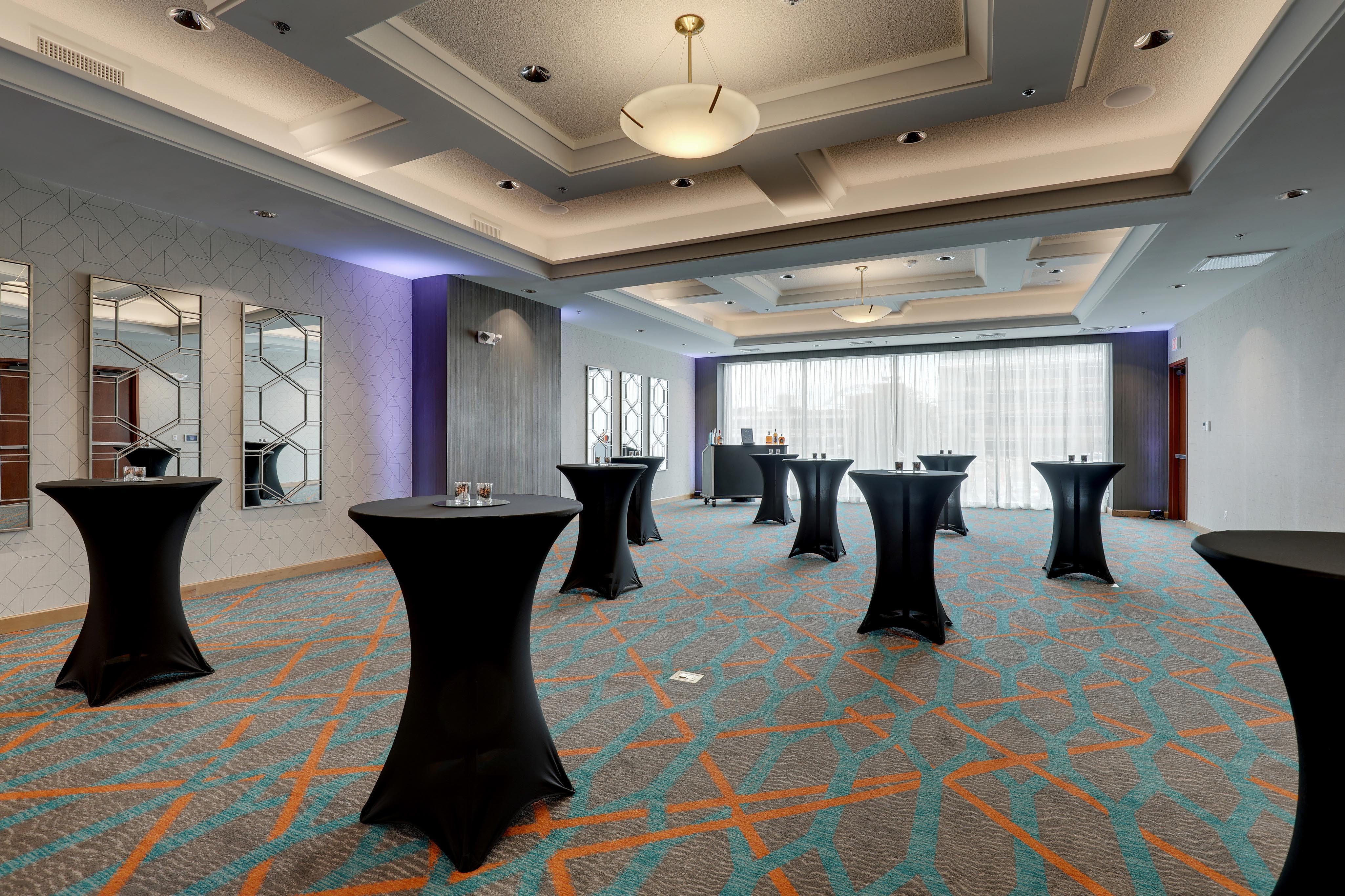 Meeting space set up with standing cocktail tables